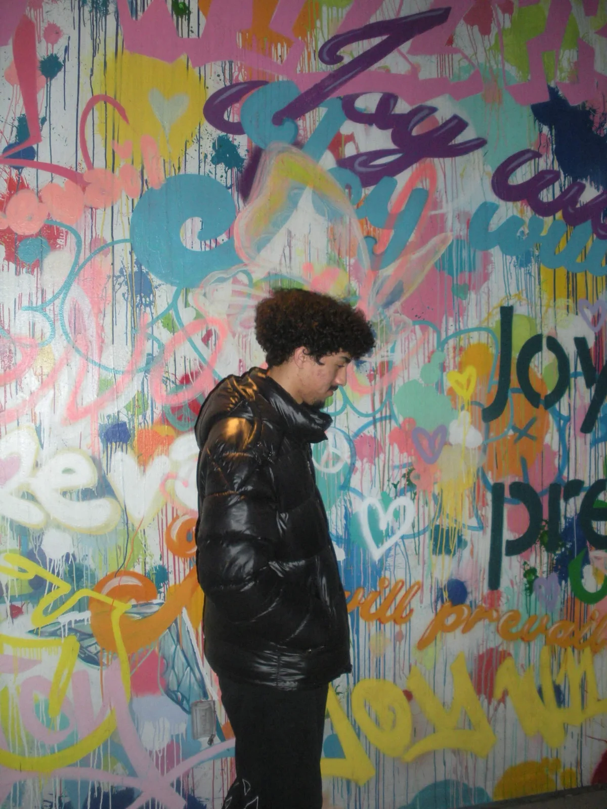 IceyyStudios profile portrait in front of a colorful mural