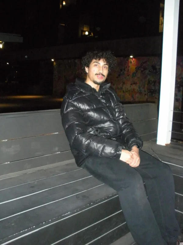 Relaxing on a bench beside a vertical light