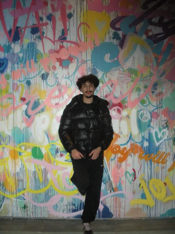 Full-length portrait at the colorful mural
