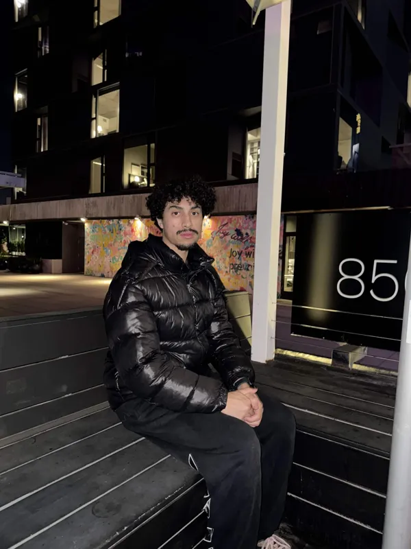 Seated portrait with the mural in the background