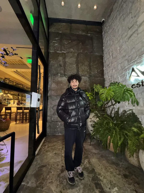 Portrait beside a stone entrance and plants
